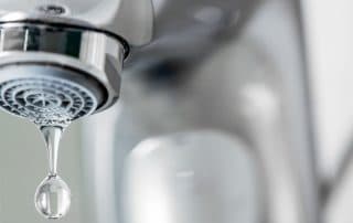 Tap closeup with dripping waterdrop