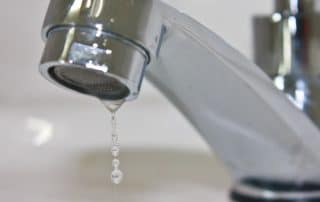 Modern faucet closeup with water drop