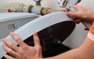Repairing water softener, plumber with a wrench