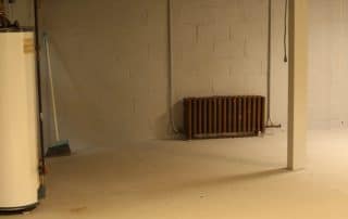 Basement view with water heater, furnace and pipes