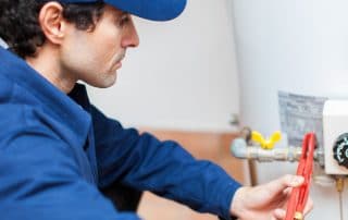 Plumber fizing a water heater