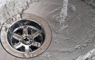 Water pouring into kitchen sink