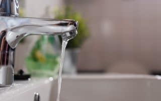 Sink and running faucet