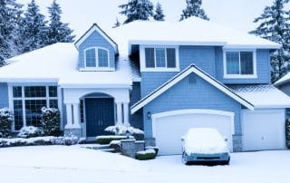 Exterior of a home coated in snow in the winter