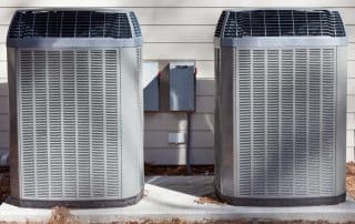 Two HVAC units outside of a home