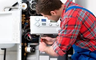 Technician servicing the gas boiler